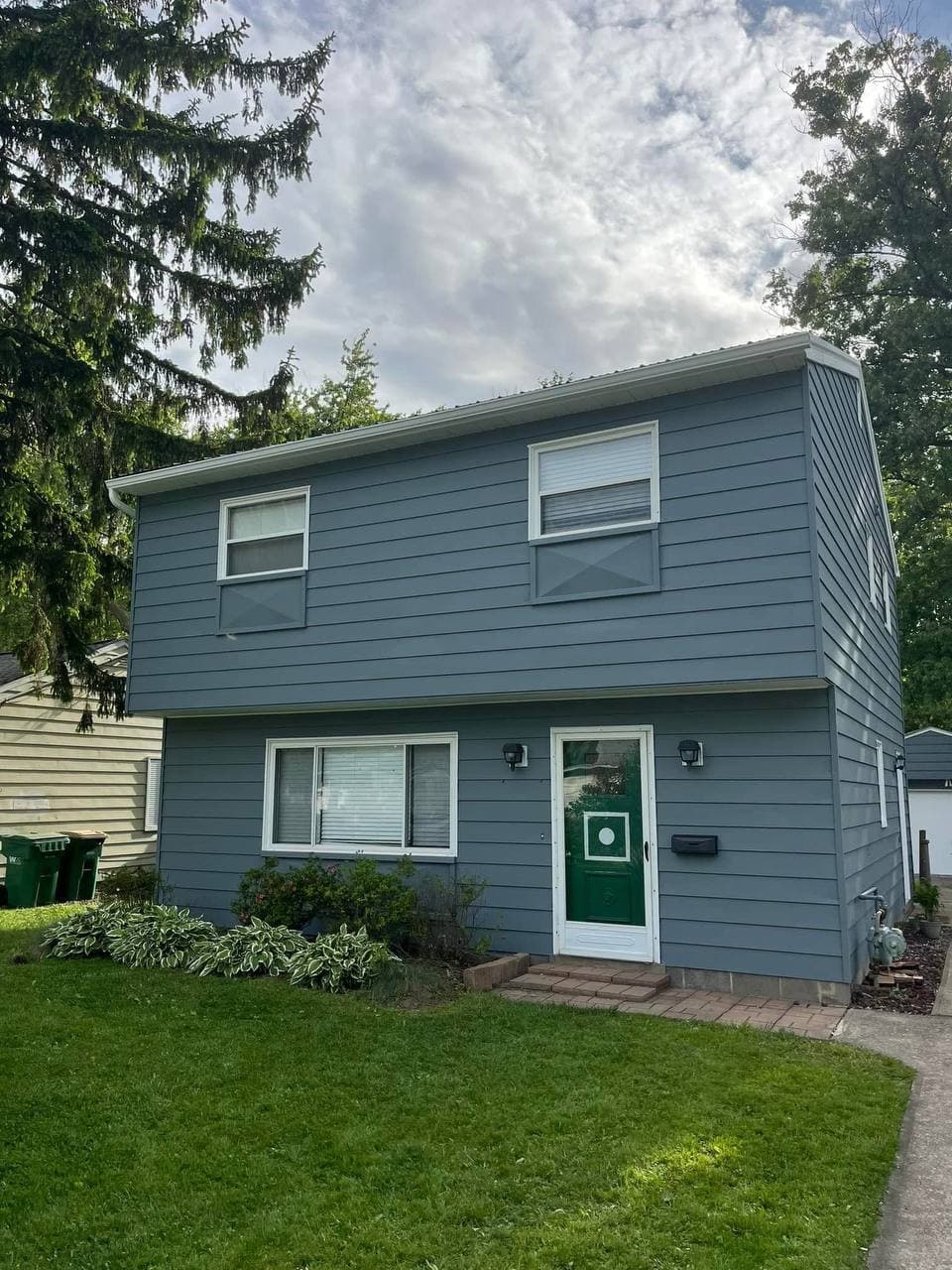 House exterior after repainting, blue-gray siding